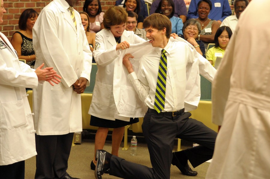 Miller is a fixture at School of Medicine events such as the White Coat Ceremony. In 2010, first-year medical student Dan Tilen, who is 6’7,” had to kneel to receive his white coat from Miller. (photo by Mary Donaldson)