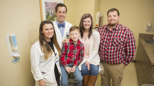 Liver transplant patient Erin Morris, second from right, with her son Corbin, husband Allen, right, Roman Perri, M.D., and Heather O’Dell, ANP-BC, at a recent follow-up appointment. (photo by Susan Urmy)