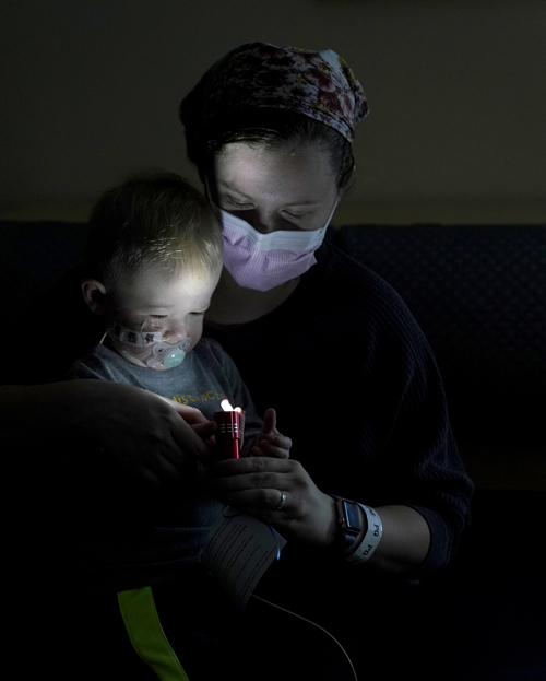 Theodore Springsteen, 16 months, enjoys playing with his flashlight with his mother, Gabrielle Springsteen, for the third annual Night Lights at Monroe Carell Jr. Children’s Hospital at Vanderbilt.