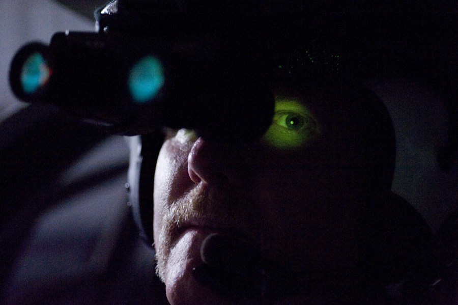Pilot Mike Cobb dons the new night vision goggles. (Photo by Joe Howell)