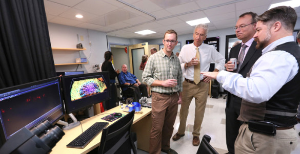Nikon’s Cumberland Dugan, right, describes one of the live-cell imaging systems in the new Vanderbilt Nikon Center of Excellence to, from left, Matthew Tyska, Ph.D., Ian Macara, Ph.D., and Jeff Balser, M.D., Ph.D. (photo by Anne Rayner)