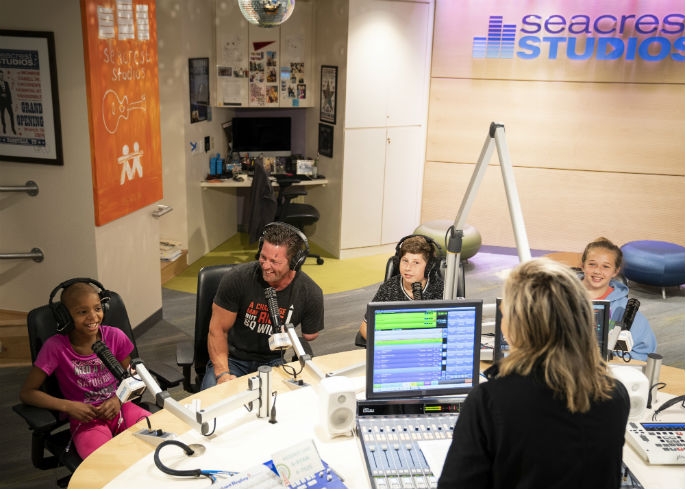 Sgt. Noah Galloway, a fitness expert and motivational speaker, interacts with patients during a visit to Seacrest Studio at Monroe Carell Jr. Children's Hospital at Vanderbilt.