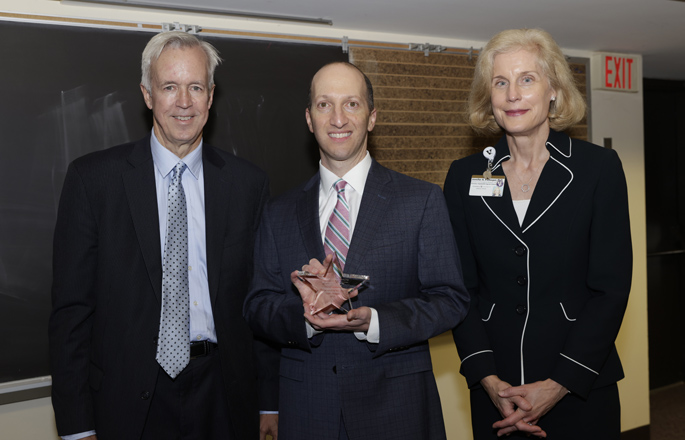 Keith Obstein, MD, MPH, center, was presented the award by Kenneth Holroyd, MD, MBA, and Jennifer Pietenpol, PhD. (photo by Donn Jones)