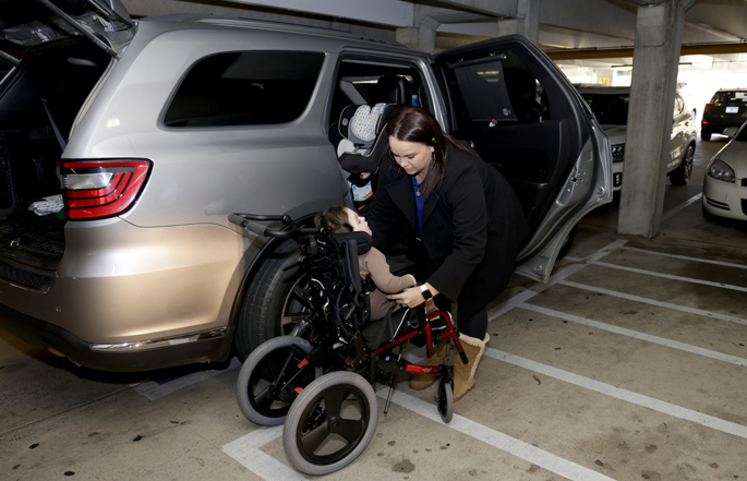 The addition space allows Becca Parker to move Samuel from his car seat to his stroller safely. (photo by Donn Jones)