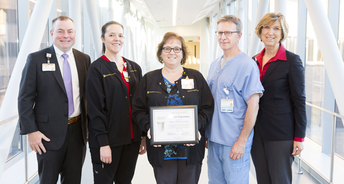 The Clinical Research Center (CRC) was one of 27 clinical areas at Vanderbilt University Medical Center that received a 2019 Excellence in Patient Experience award in recognition of exceptional performance and commitment to service excellence. Shown here, Scott McCarver, MHA, left, and Robin Steaban, MSN, RN, right, present the Clinical Research Center’s award to, from left, Crystal Rice, RN, BSN, Lana Howard, RN, CCRP, and Lamar Bowman, RN, BSN. Not pictured: Deloris Lee, RN, BSN.