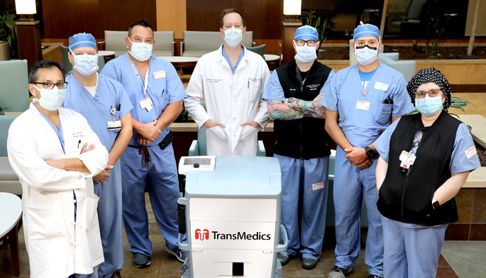 Members of the heart transplant perfusion and recovery team pose with the TransMedics system used to preserve organs during transport. From left are Ashish Shah, MD, Harry Moneypenny, CCP, LCP, Matthew Warhoover, MS, CCP, LCP, Jordan Hoffman, MD, Kyle Rider, CCP, Joey Lepore, RN, CCP, LCP, and Marina Mailyan, MS, CCP, LCP.