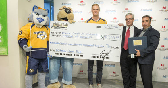 The Nashville Predators presented a check this week to Monroe Carell Jr. Children’s Hospital at Vanderbilt to help fund pediatric cancer research. On hand for the ceremony were, from left, Predators mascot Gnash, Children’s Hospital mascot Champ, Predators goaltender Pekka Rinne, Steven Webber, MBChB, MRCP, and Predators President and CEO Sean Henry. (photo by John Russell)