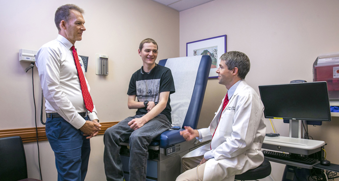 Pediatric neurologist Kevin Ess, MD, PhD, left, and pediatric neurosurgeon Robert Naftel, MD, follow up with patient Daniel Lookabaugh, who has epilepsy.