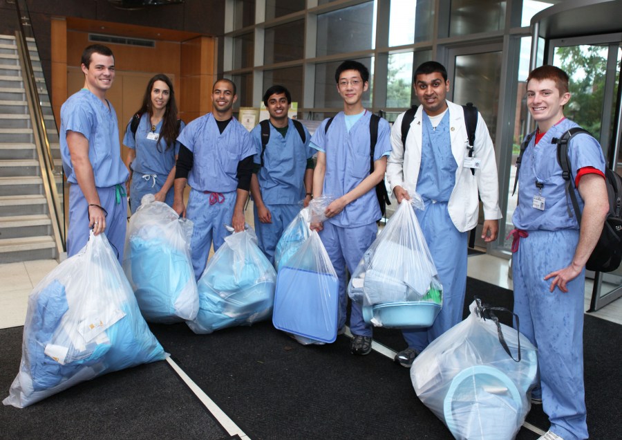 School of Medicine students helping to collect unused medical items to be donated to hospitals in the developing world include, from left, John Andereck, Michele Vigor, Tyler Merceron, Harish Krishmnamoorthhi, Everett Gu, Rishi Naik and Tyler Windsors. (photo by Susan Urmy)