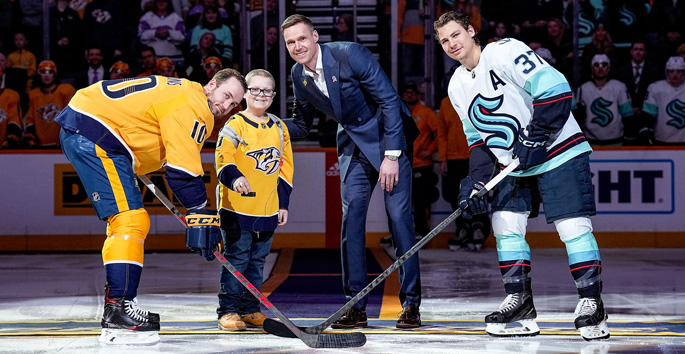 Child ambassador Brody Reiner drops the puck at the Hockey Fights Cancer game March 25. Brody, a patient of Monroe Carell Jr. Children’s Hospital at Vanderbilt, is joined on the ice by retired goalie Pekka Rinne, Predators player Colton Sissons, left, and Seattle Kraken player Yanni Gourde.