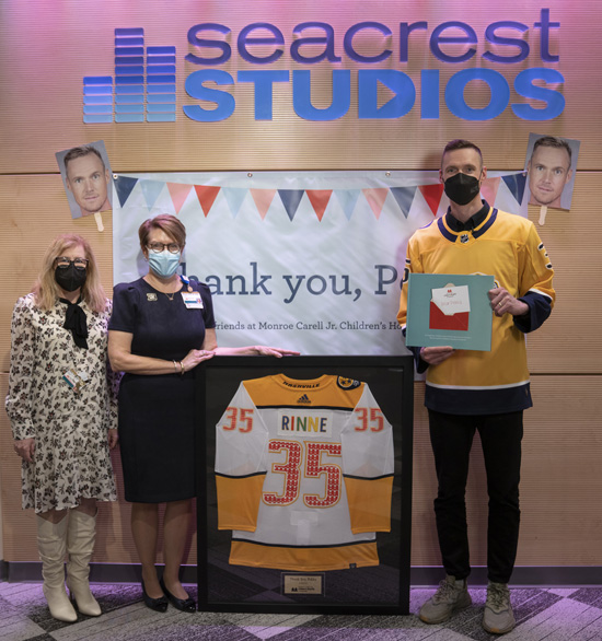 Debra Friedman, MD, left, and Meg Rush, MD, presented Rinne with a custom-made version of his Predators jersey, which will permanently hang inside Seacrest Studio. (photo by Cayce Long)