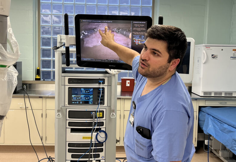 Aimal Khan, MD, works with residents on improving their robotic skills during an annual Resident Robotics Teaching Lab at Vanderbilt University Medical Center.