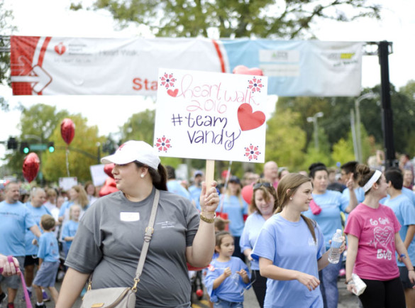  Sarah Stein, a nurse practitioner with the heart transplant program at Vanderbilt University Medical Center, holds a Team Vandy sign during the American Heart Association’s 2016 Greater Nashville Heart Walk. The annual event drew 9,000 walkers to the VUMC campus Oct. 15. Early counts show more than $1.7 million was raised in Nashville. (photo by Kristi Irving)