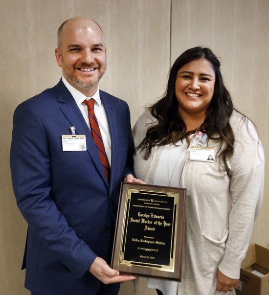 Erika Rodriguez-Muñoz, LMSW, receives her plaque from Josh Owens, LCSW, director of Transition Management, after she was named Carolyn Edwards Social Worker of the Year at the annual Social Work Luncheon. Rodriguez-Muñoz works at Vanderbilt Women’s Health One Hundred Oaks and is project coordinator for the Obstetrics Opioid Use Disorder Quality Improvement project and a leader for Team HOPE, a multidisciplinary team that focuses on the optimization of opioid exposed newborns. She was one of 20 nominees for the honor, which is named for longtime VUMC social worker Carolyn Edwards. The luncheon and award presentation were part of the Transition Management Office’s observance of March as Social Work Month.