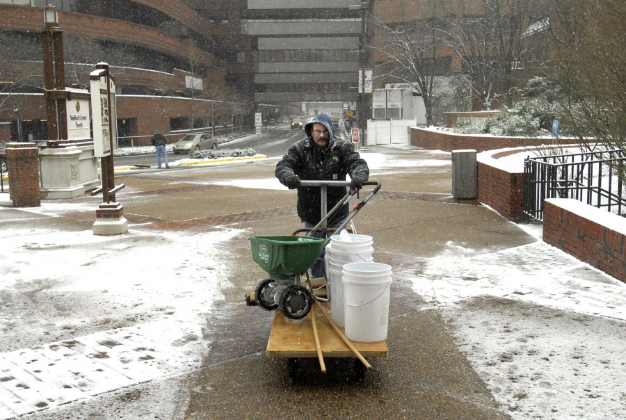 Reed McDonald heads back into Medical Center North to get more de-icer to spread on the walkways. (photo by Anne Rayner)