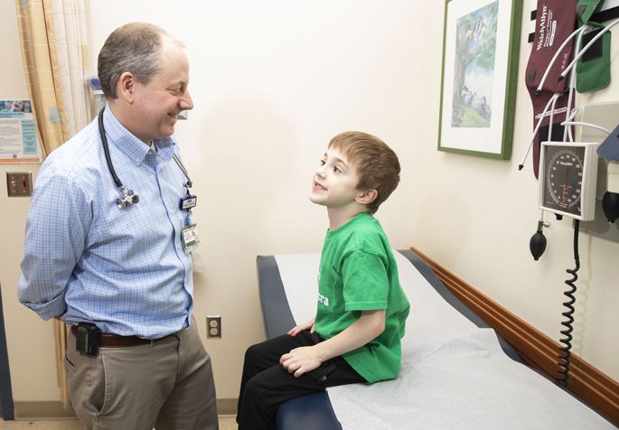 Jonathan Soslow, MD, talks with Soren Saxon, one of the first patients to be treated with the new therapy for Duchenne muscular dystrophy. (photo by Susan Urmy)