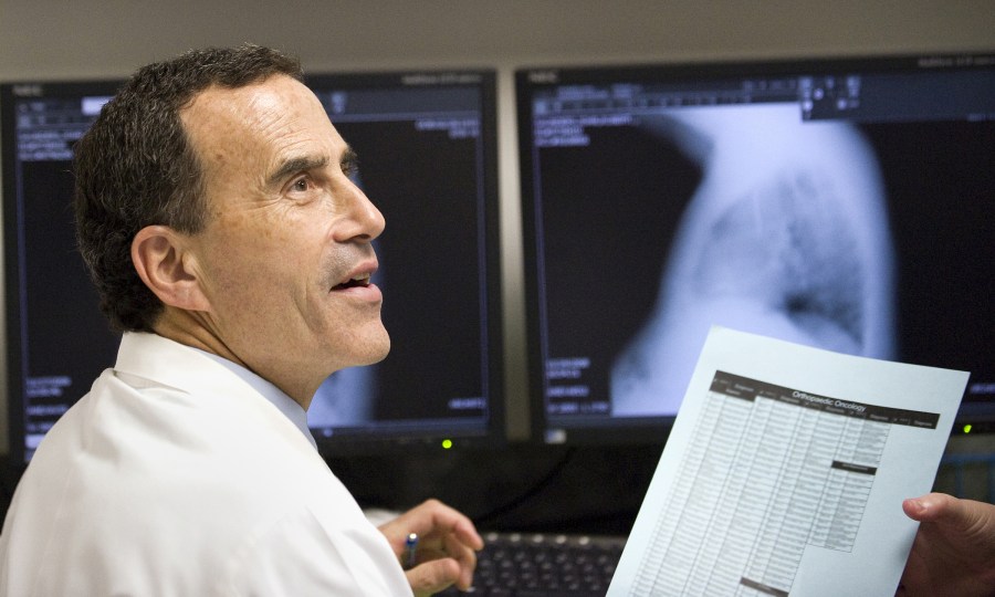 Herb Schwartz, M.D., reviews charts at the  Vanderbilt Orthopaedic Institute in Medical Center East. (photo by Joe Howell)