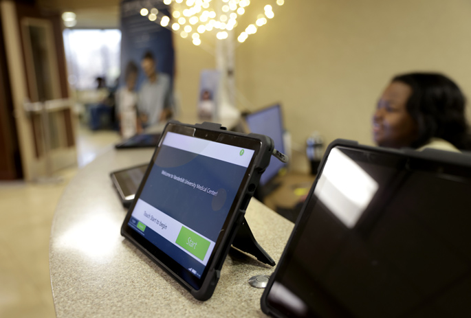Patients can quickly complete check-in at Vanderbilt Health adult ambulatory clinics using a tablet provided at a centralized welcome desk or by using the My Health at Vanderbilt secure patient portal app on their own phone or tablet. (photo by Donn Jones)
