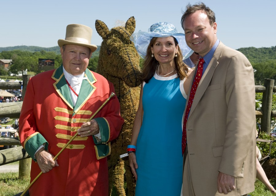 Jeff Balser, M.D., Ph.D., and his wife, Melinda, chat with George Sallee, official bugler of the Iroquois Steeplechase. (photo by Joe Howell)