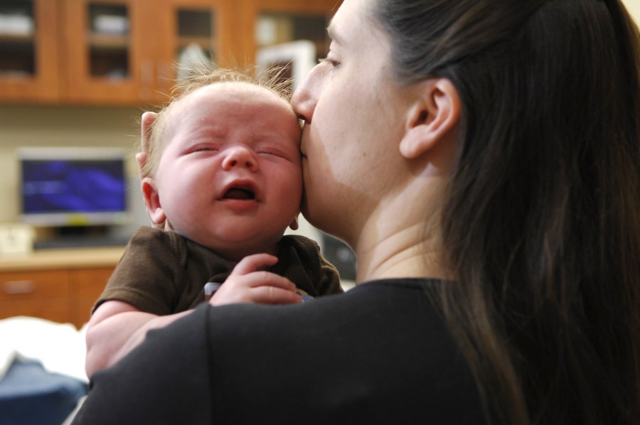 April Dodd holds her son, Andrew, before his recent procedure to correct tongue tie. (photo by Anne Rayner)