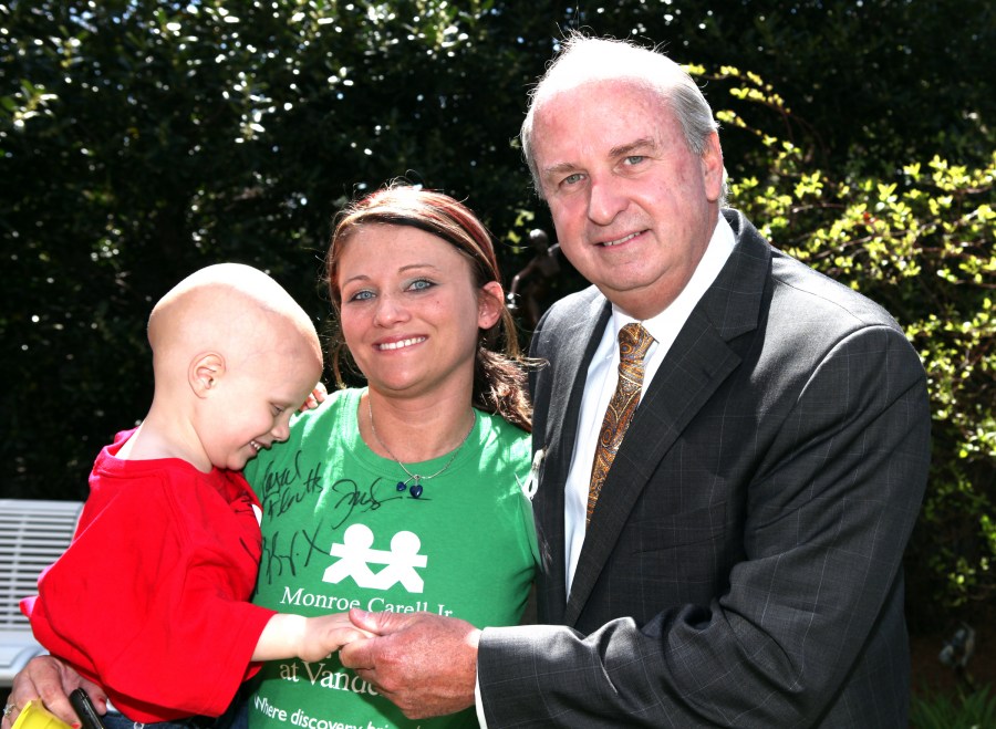 John Brock III, M.D., with Jennifer Salyers and her son, Kezden, 3, at the beam signing event. (photo by Susan Urmy)