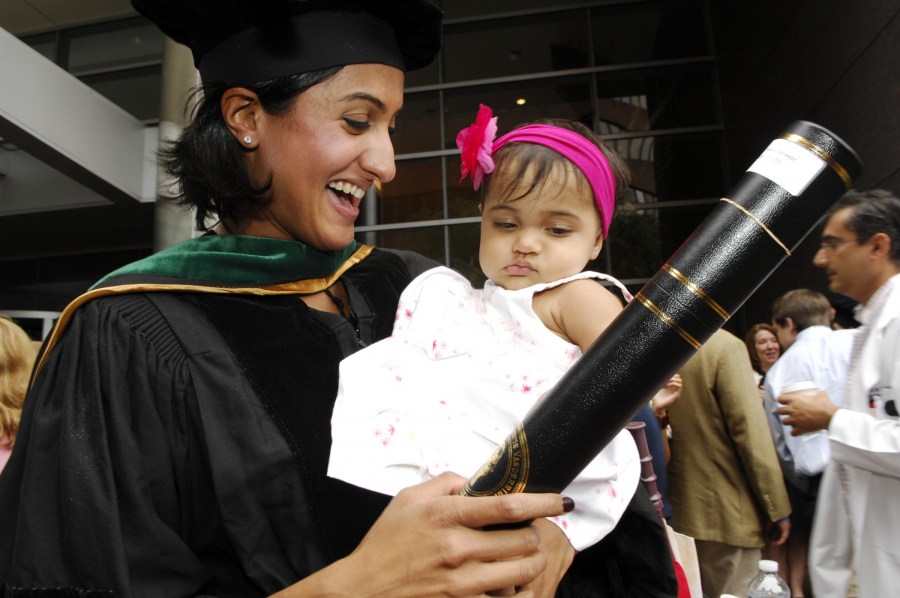 VUSM’s Yamini Rao, shows her diploma to her niece, Manisha Nilakantan. (photo by Anne Rayner)