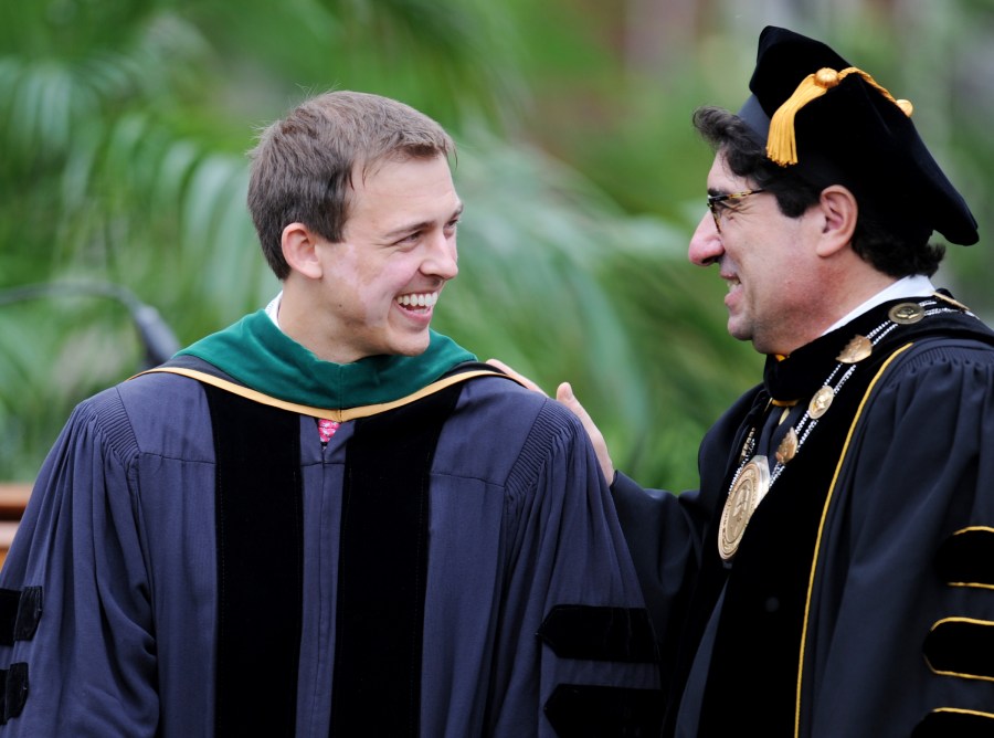 Brandon Litzner, left, is congratulated by Vanderbilt Chancellor Nicholas S. Zeppos after being awarded the VUSM Founder’s Medal. (photo by Joe Howell)