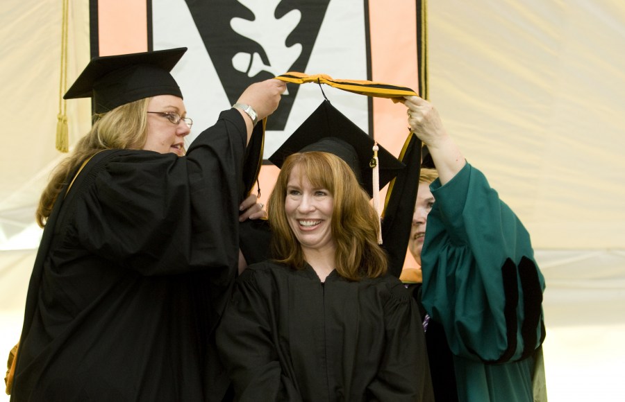 Kathy Perry beams as she receives her School of Nursing academic hood. (photo by Susan Urmy)