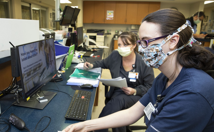 Stephanie Murphy, left, and Lori Fields, monitor systems in the ICU at Vanderbilt Wilson County Hospital during last week’s transition to new IT systems. (photo by Susan Urmy)