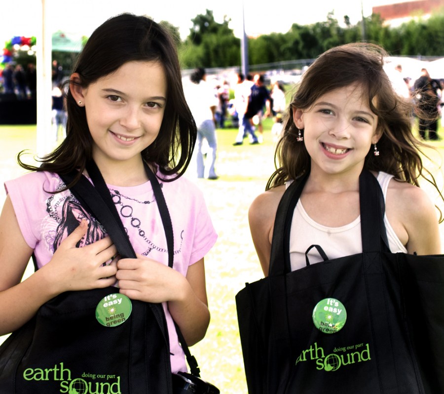 Rebecca Beamer, 9, left, and sister Emily, 8, model their green apparel.