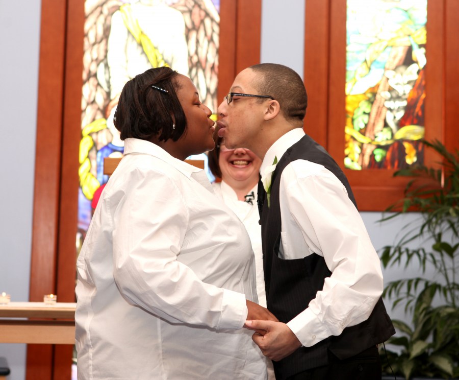 Holt kisses his bride, Narkita Dobson, after the couple exchanged vows. (photo by Susan Urmy)