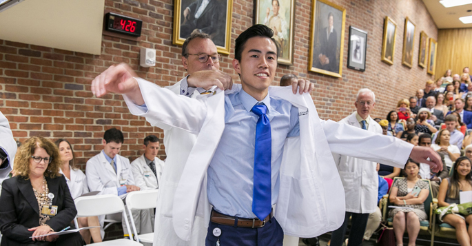 Thomas Li receives his white coat from Jeff Balser, MD, PhD, at last Friday’s event in 208 Light Hall.