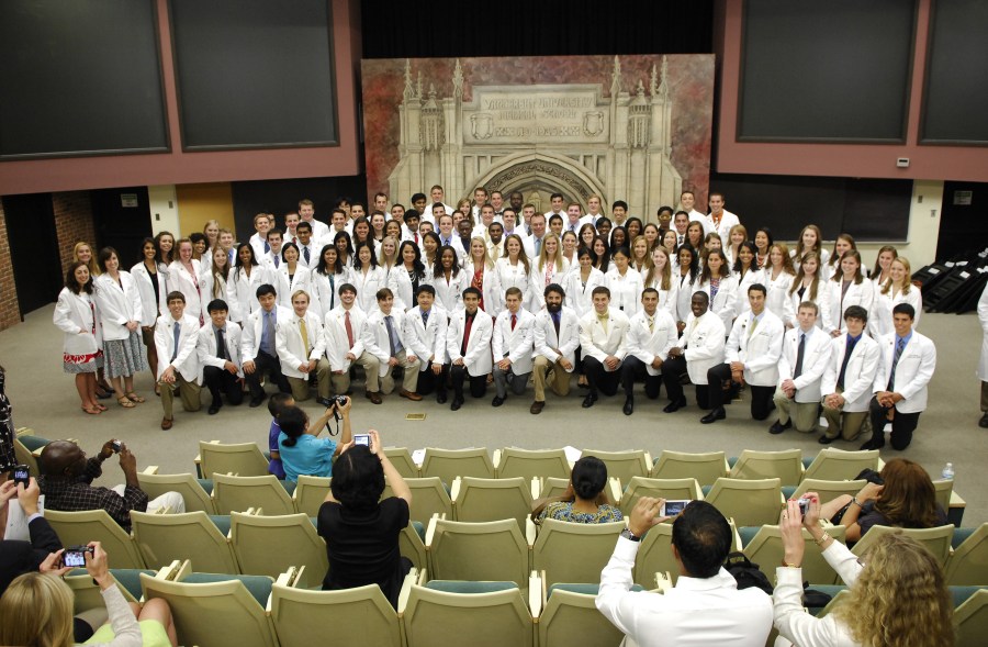 The 104 members of the School of Medicine’s incoming class pose for photos after the ceremony. (photo by Anne Rayner)
