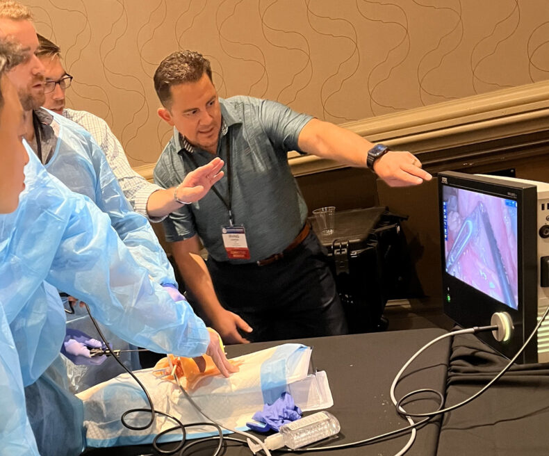 Irving J. Zamora, MD, MPH, trains surgical fellows on robot-assisted surgical techniques.