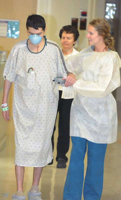 Heart patient Yaroslav Zubkov walks with physical therapist Tara La Fevor, right, and his mother, Maria Zubkov. (photo by Mary Donaldson)