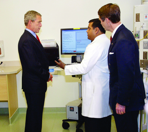 During a visit to VUMC in May, 2004, President George Bush talks with Neal Patel, M.D., as U.S. Sen. Bill Frist, right, looks on. (photo by Dana Johnson)