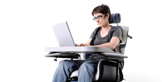 woman using electric wheelchair and computer