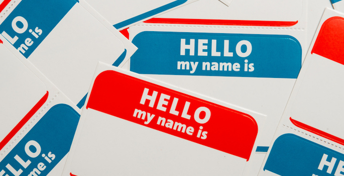A stack of blue and red "Hello, my name is" name tags or badges