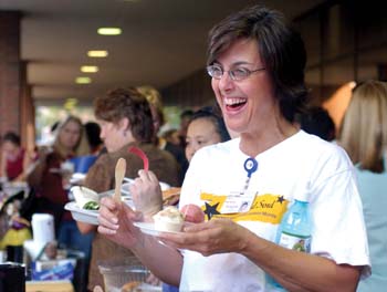 Lori Cowan, a fitness associate at Health Plus, shows her joy over the Ben & Jerry's Ice Cream booth, one of the vendors at the Taste of Vandy event last week. The Taste of Vandy is part of Employee Celebration Month. (photo by Dana Johnson)