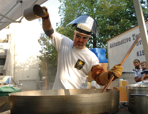 Jack MacDowall pours popcorn for his business, Moose Head Kettle Corn, at Friday’s Finale. (photo by Anne Rayner)