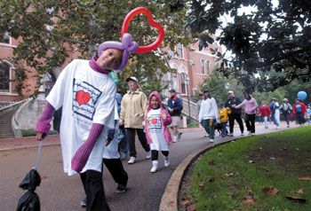 A heart-shaped balloon adorns a young walker as she winds her way through the Heart Walk route.