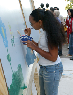 Mehalet Theodors leaves her mark on the mural at the Grand Finale.
Photo by Susan Urmy