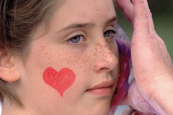 Kristan Staley gets her face painted at this year's American Heart Association Heart Walk. (photo by Dana Johnson)
