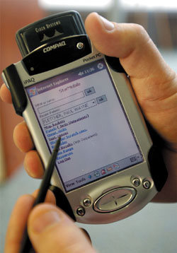 Hand-held PDAs are being used to access patient information. (photo by Dan Johnson)