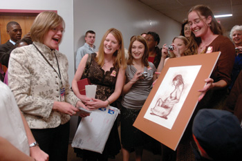 Mavis Schorn, M.S.N., R.N., program director of Nurse-Midwifery at the Vanderbilt University School of Nursing, left, reacts with surprise to the artwork her students presented to her at the pinning ceremony.
Photo by Dana Johnson