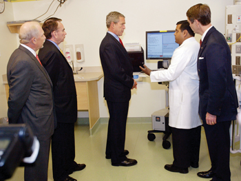 During a visit in May, President Bush listens as Neal Patel, M.D., right, explains a computer system in a patient room as Harry Jacobson, M.D., left, then-Secretary of Health and Human Services Tommy Thompson, second from left, and U.S. Sen. Bill Frist, right, look on.
photo by Dana Johnson