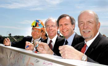 Dr. Arnold Strauss, Monroe Carell Jr., Mayor Bill Purcell, and Dr. Harry R. Jacobson sign the final beam to be lifted atop the new hospital. (photo by Dana Johnson)