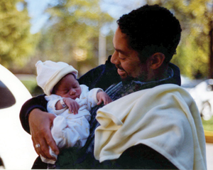 Harris holds his daughter, Maria, shortly after her birth four years ago.