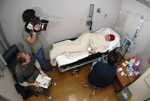 Filmmakers Jeremy Carlson, left, and Colby Sands interview patient Sarah Conley while Connie Crawford Koonce, R.N., prepares her for chemotherapy.  (photo by Neil Brake)