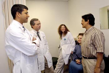 From left, Dr. Ravi Chari, Dr. Will Chapman, and April Clements, RN and liver transplant coordinator, talk with Maria and Luis Nunez at a clinic appointment this week. Luis Nunez was Vanderbilt's 400th liver transplant patient, and Drs. Chari and Chapman were the surgeons. (photo by Dana Johnson)